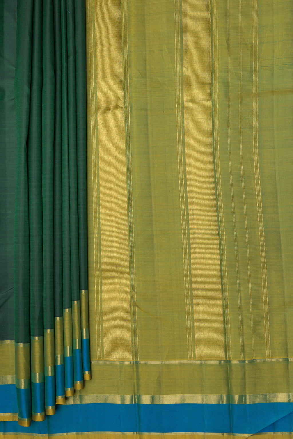 Pleats and pallu of Bottle Green Kanjivaram Silk Saree with Plain Body and Zari Border. 