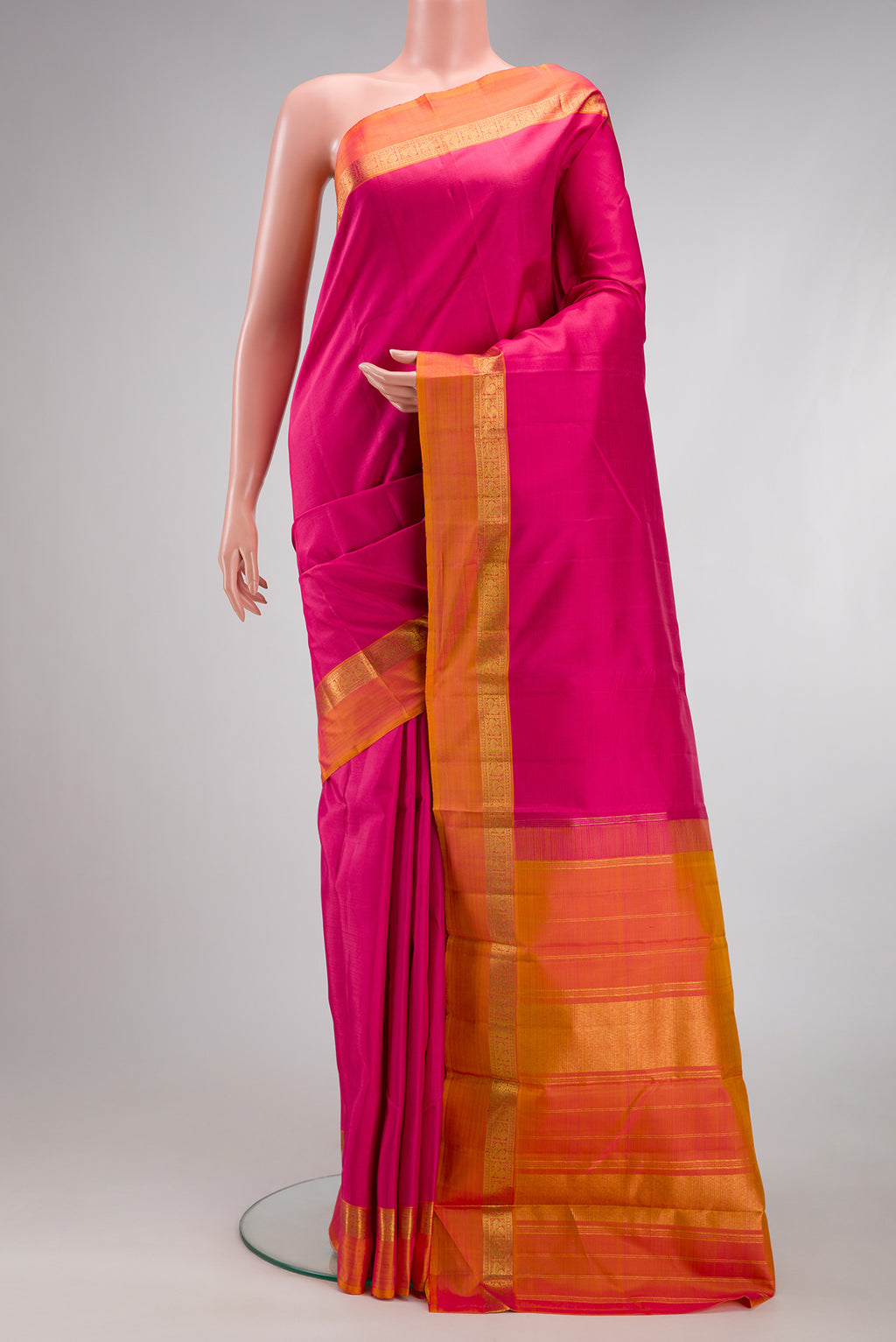 Pink Kanjivaram Silk Saree with Plain Body and Zari Border.  displayed on a mannequin