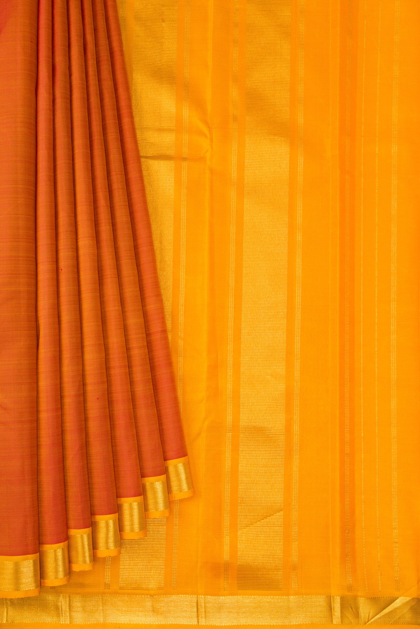 Pleats and pallu of Brick Orange Kanjivaram Silk Saree with Plain Body and Zari Border. 