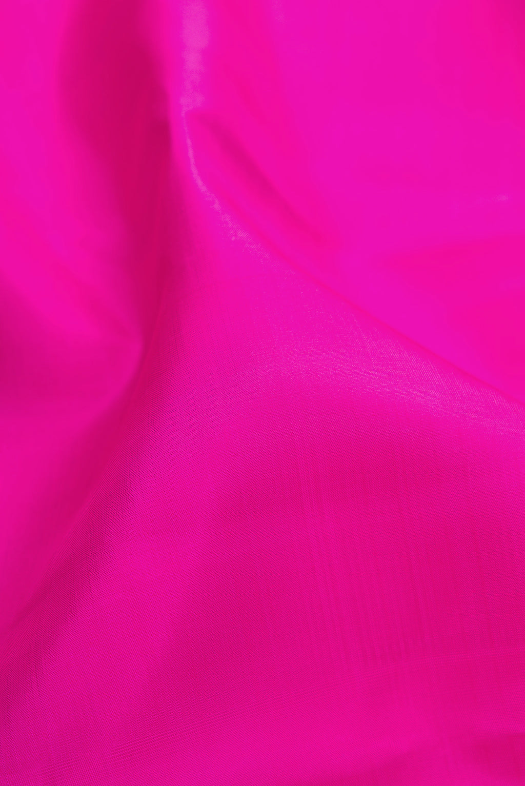 Close up of Magenta Kanchipuram Silk Saree with Plain Body and Zari Border.  displaying folds