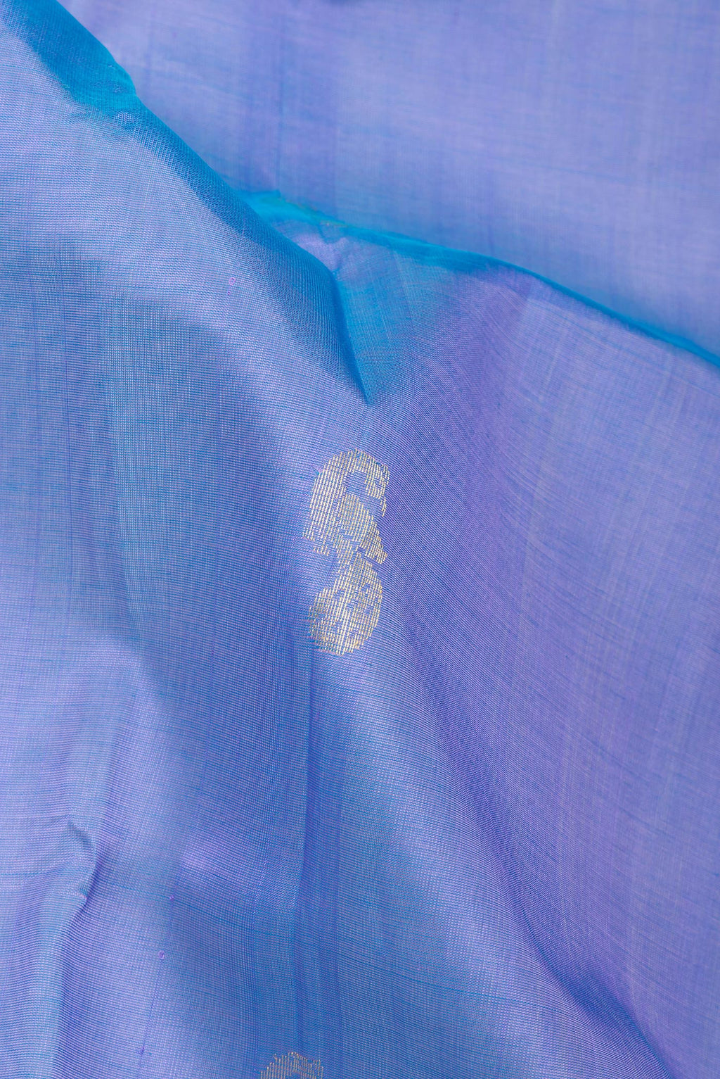 Close up of Maya Blue Silk Cotton Saree with Zari Butta on the body and Zari Border.  displaying folds