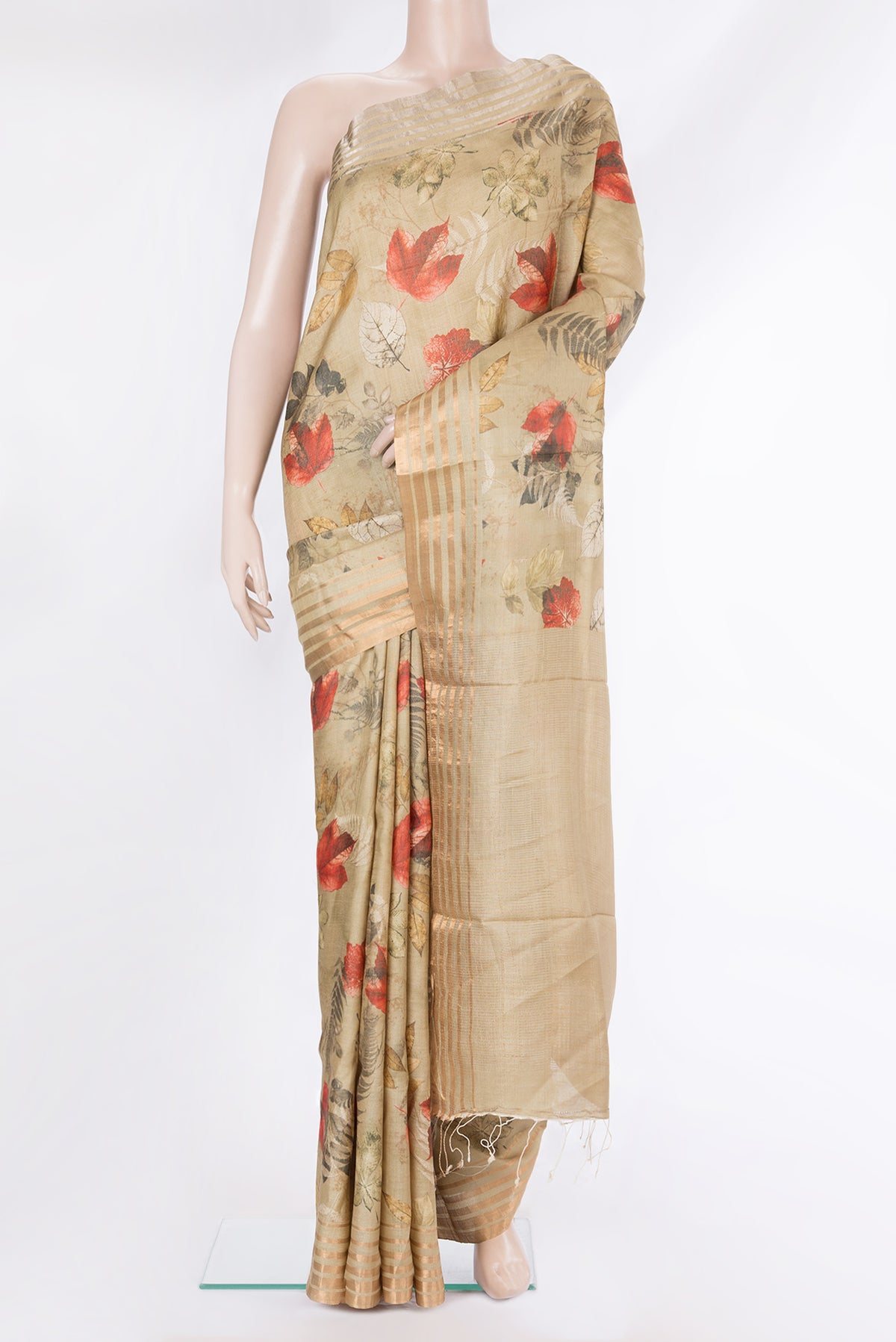 Golden Tussar Saree with Printed design on the body and Zari Border.  displayed on a mannequin