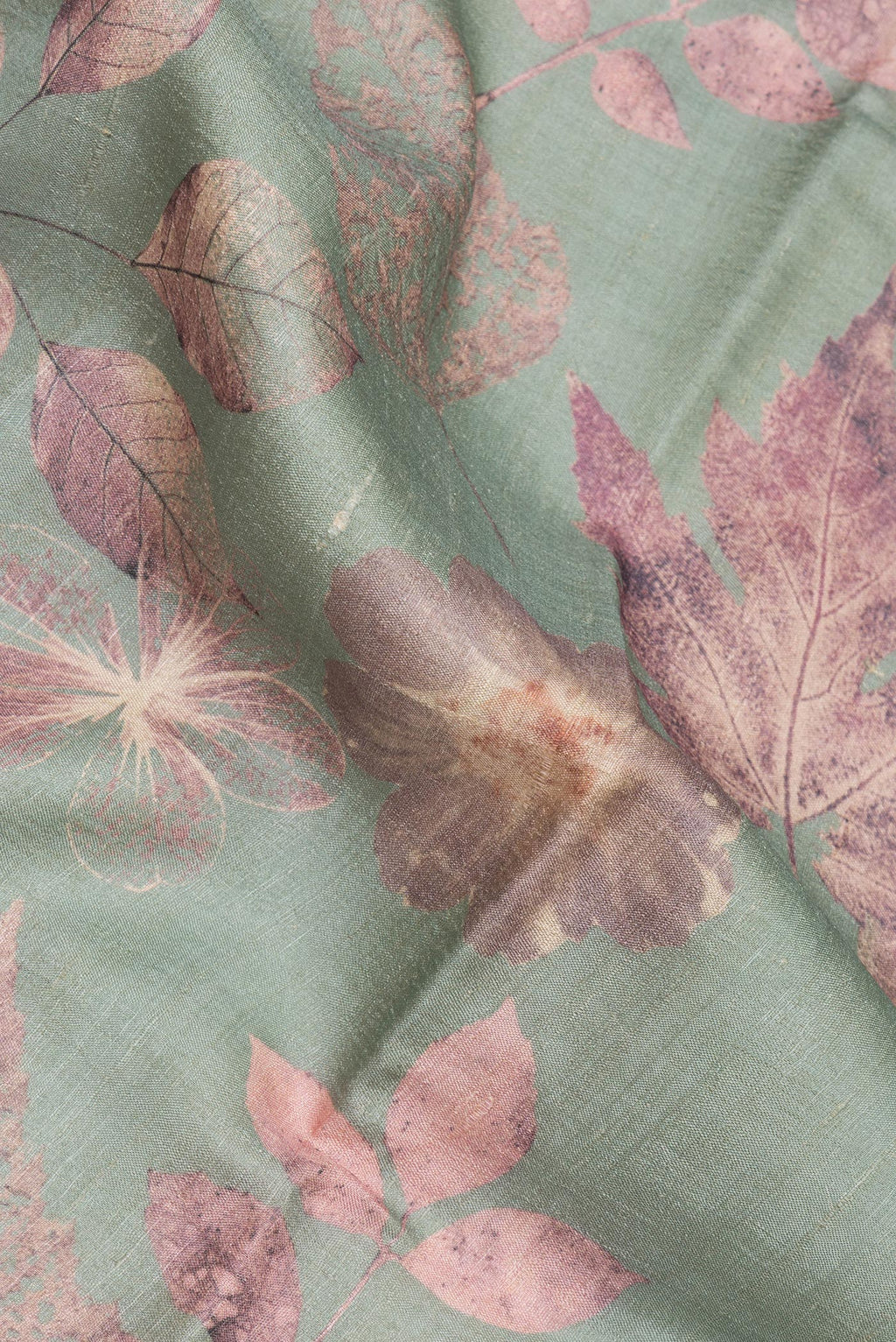 Close up of Sage Green Tussar Saree with Printed design on the body and Thin Zari Line.  displaying folds