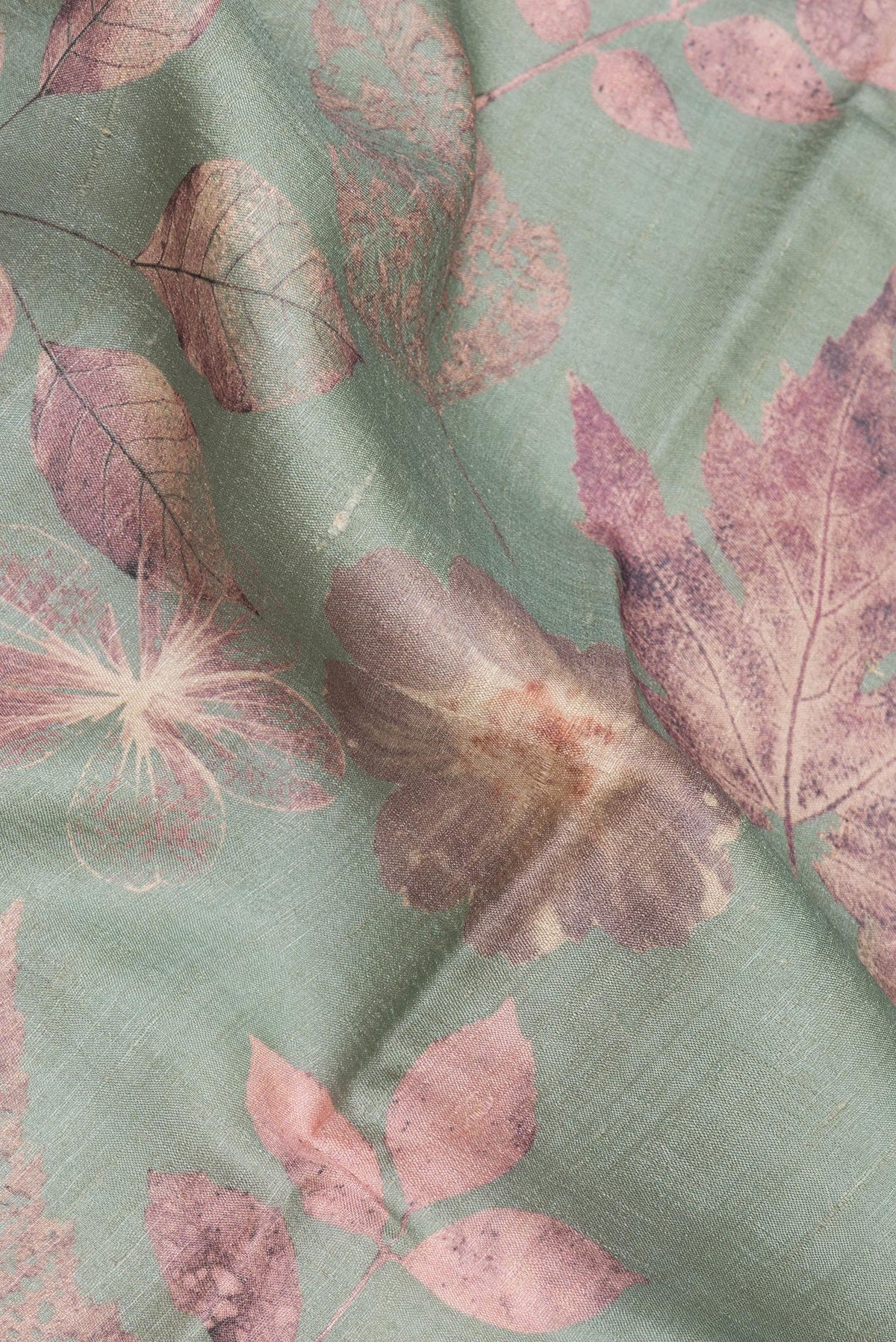 Close up of Sage Green Tussar Saree with Printed design on the body and Thin Zari Line.  displaying folds