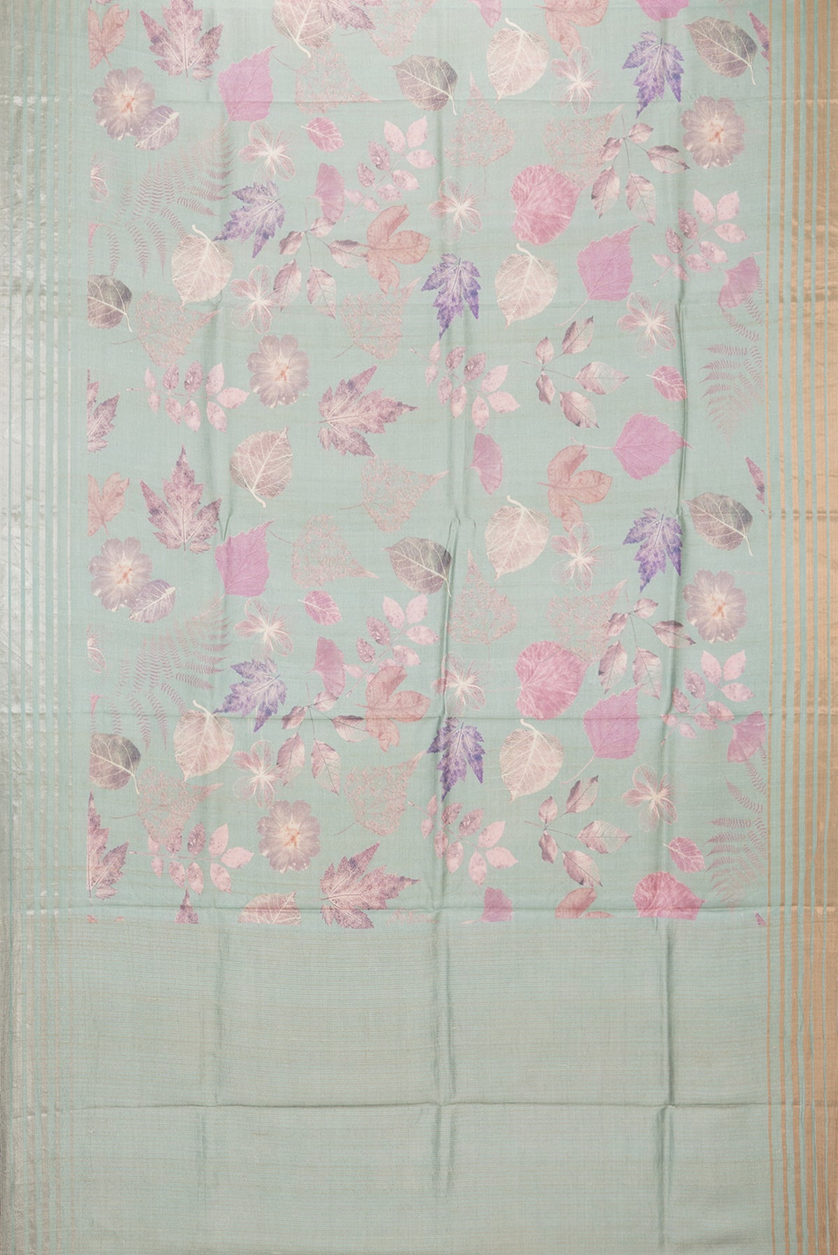 Flat view of Sage Green Tussar Saree with Printed design on the body and Thin Zari Line. 