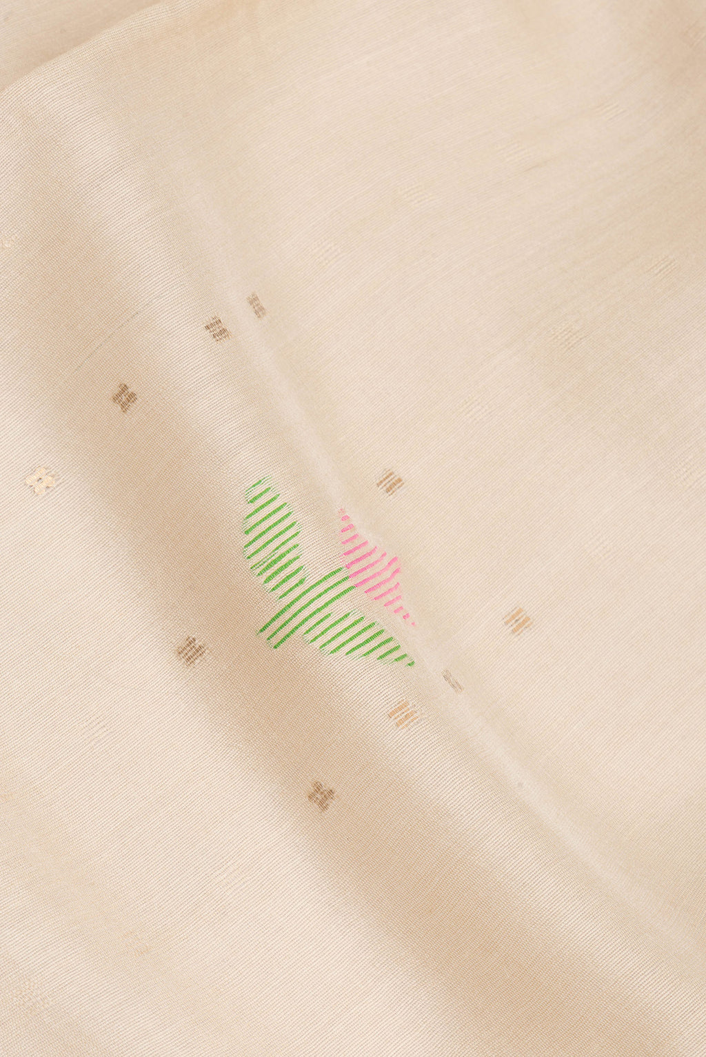 Close up of Beige Dual Tone Tussar Saree with Embroidery on the body and Fancy Border.  displaying folds