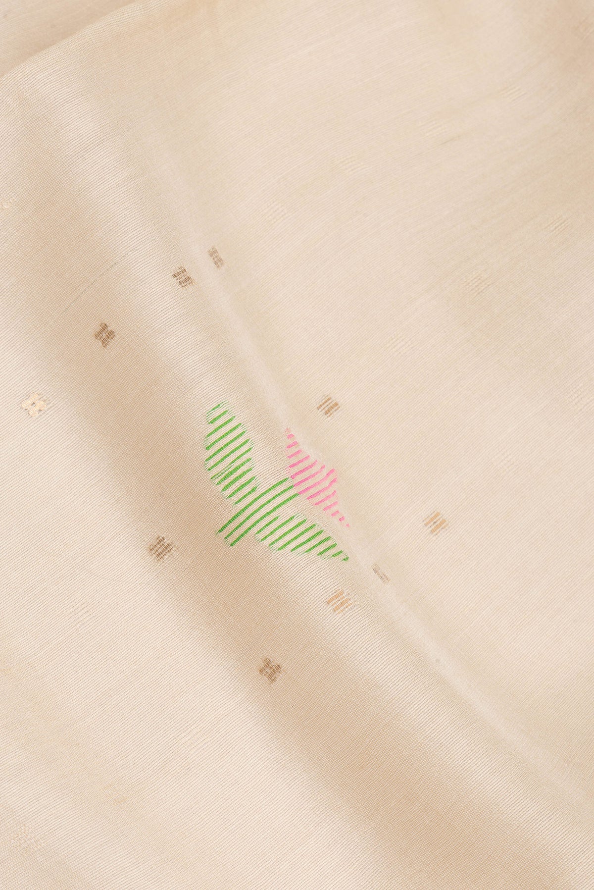 Close up of Beige Dual Tone Tussar Saree with Embroidery on the body and Fancy Border.  displaying folds