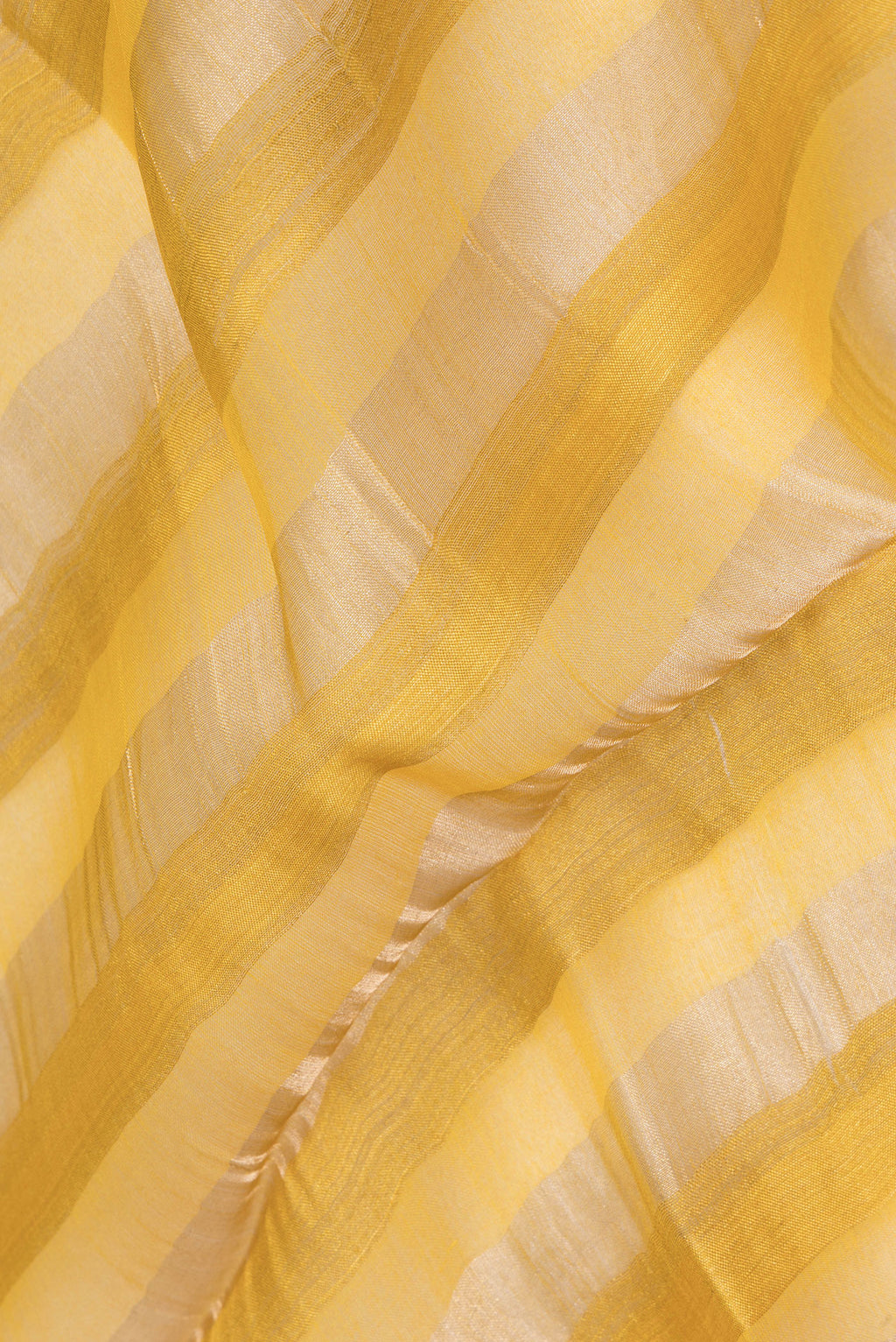 Close up of Yellow Tussar Saree with Floral Print on the body and Fancy Border.  displaying folds