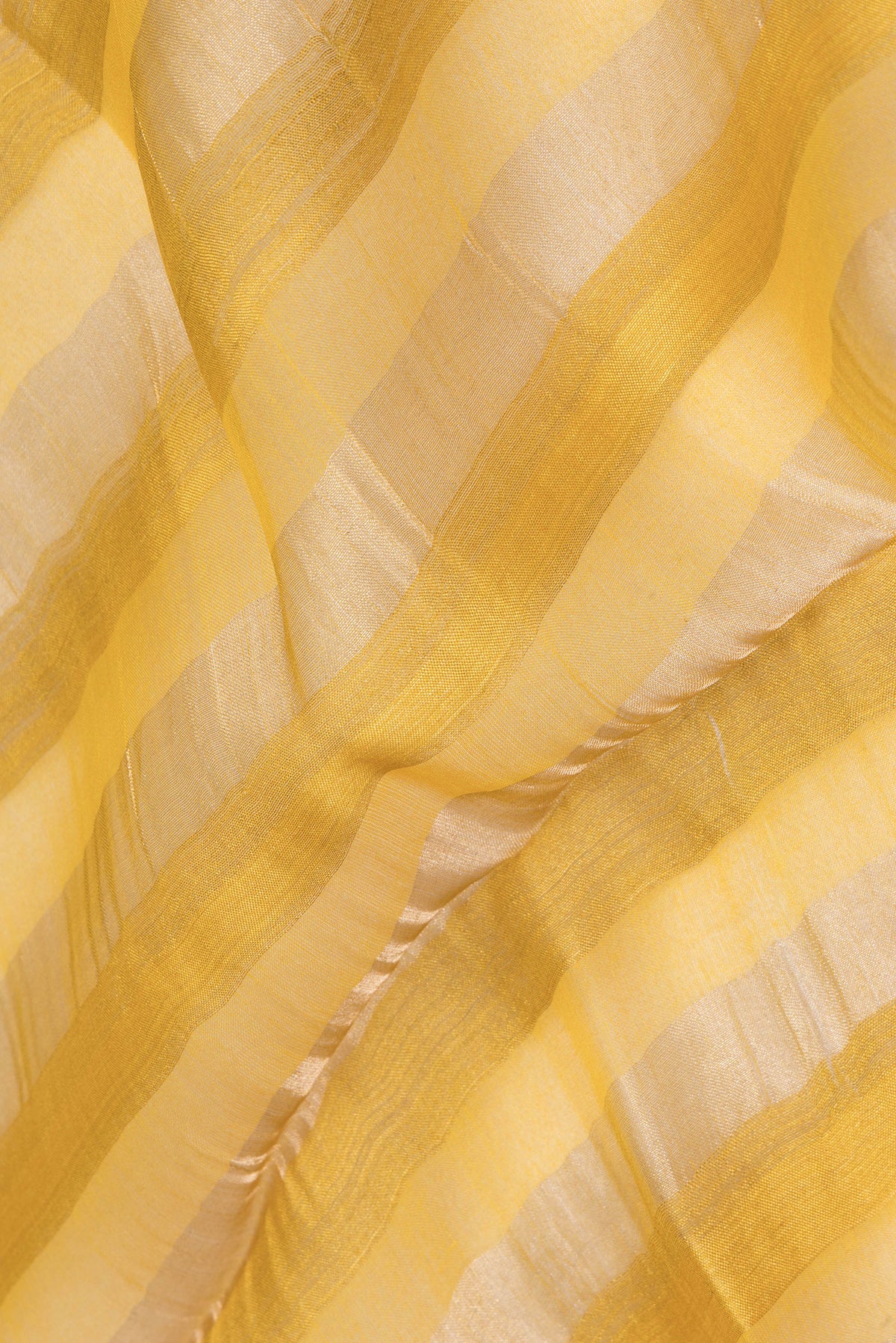 Close up of Yellow Tussar Saree with Floral Print on the body and Fancy Border.  displaying folds
