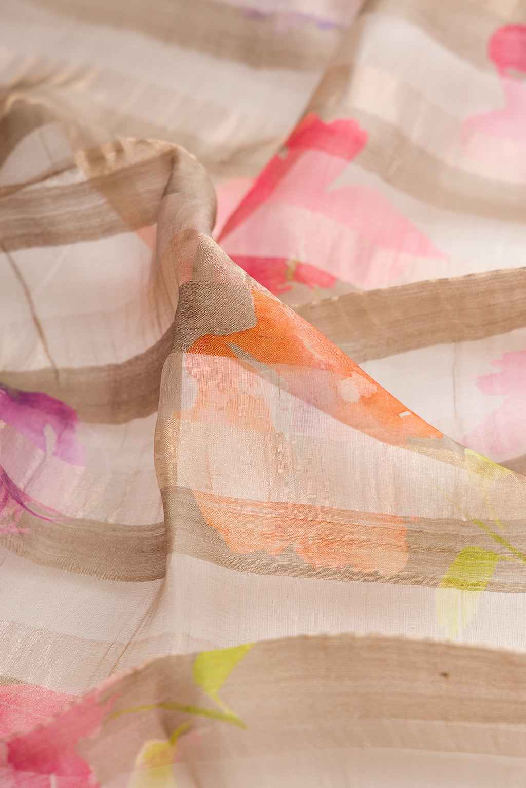 Close up of Dark Beige Tussar Saree with Stripes on the body and Zari Border.  displaying folds