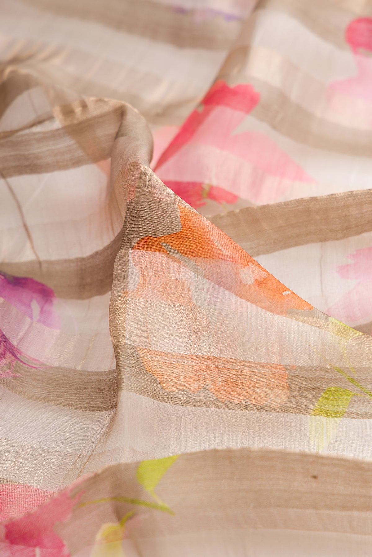 Close up of Dark Beige Tussar Saree with Stripes on the body and Zari Border.  displaying folds