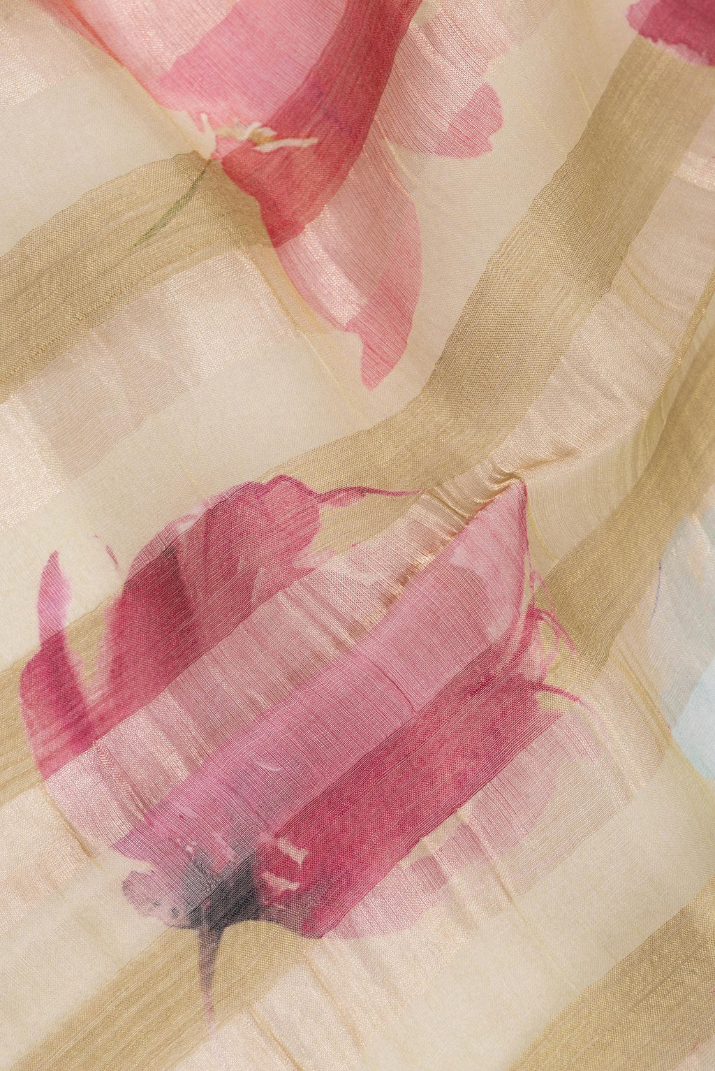 Close up of Dark Beige Tussar Saree with Floral Print on the body and Fancy Border.  displaying folds