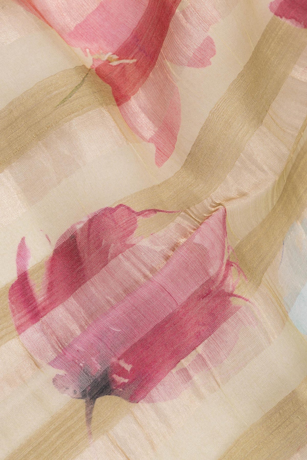 Close up of Dark Beige Tussar Saree with Floral Print on the body and Fancy Border.  displaying folds