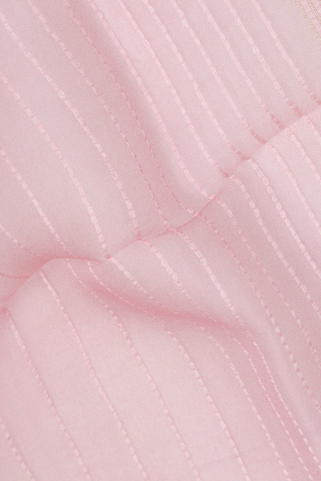 Close up of Rose pink Organza Saree with Stripes on the body and Fancy Border.  displaying folds