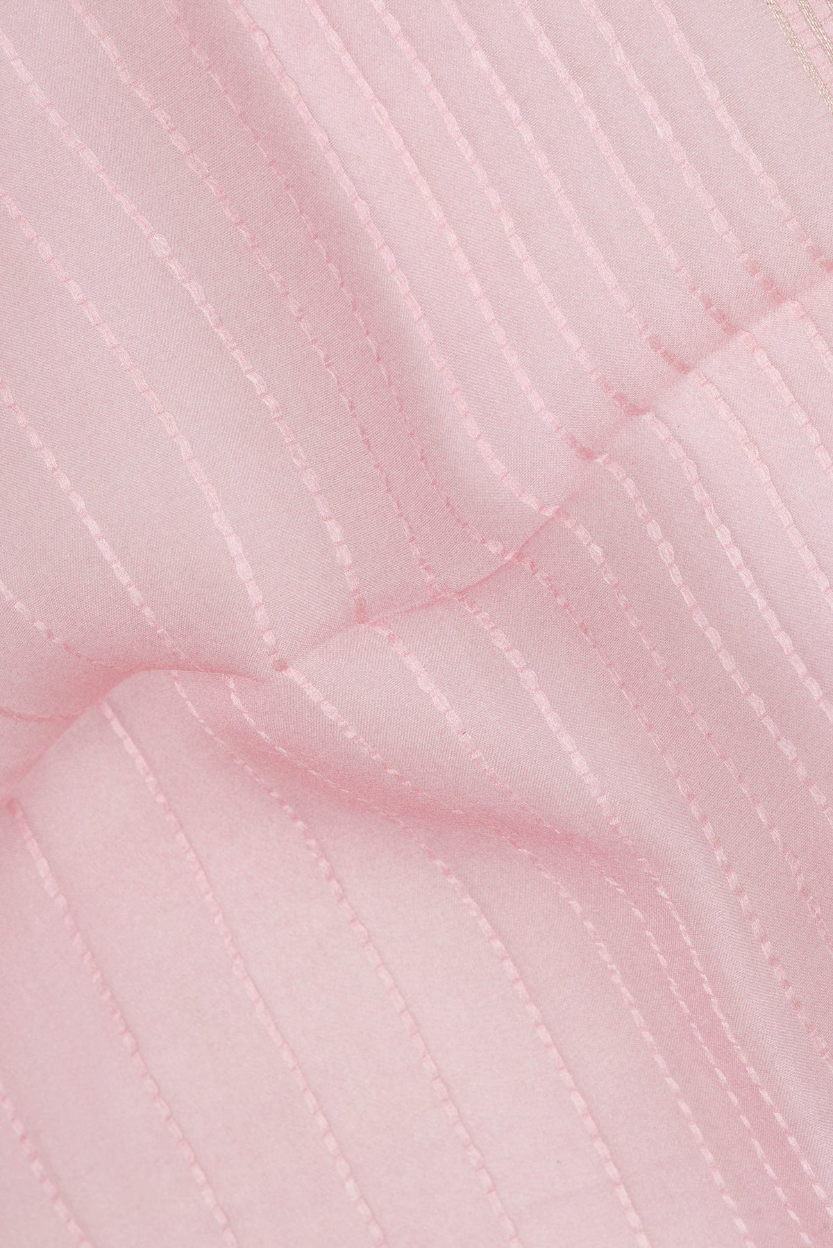 Close up of Rose pink Organza Saree with Stripes on the body and Fancy Border.  displaying folds