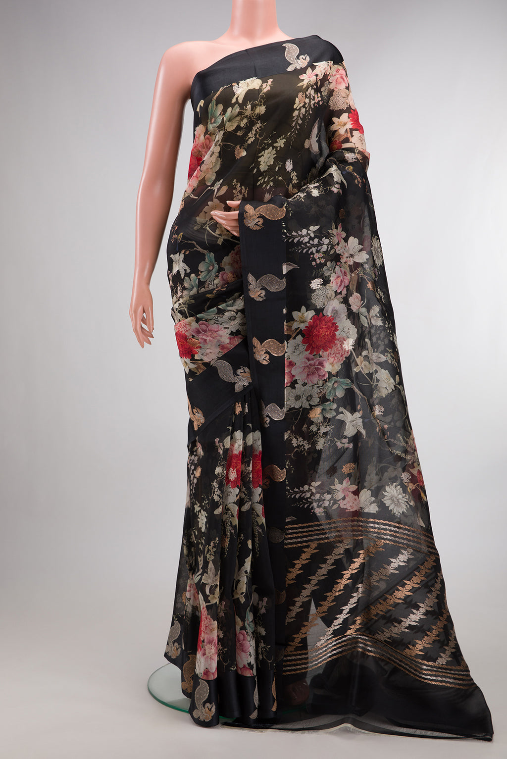 Black Organza Saree with Floral Print on the body and Fancy Border.  displayed on a mannequin