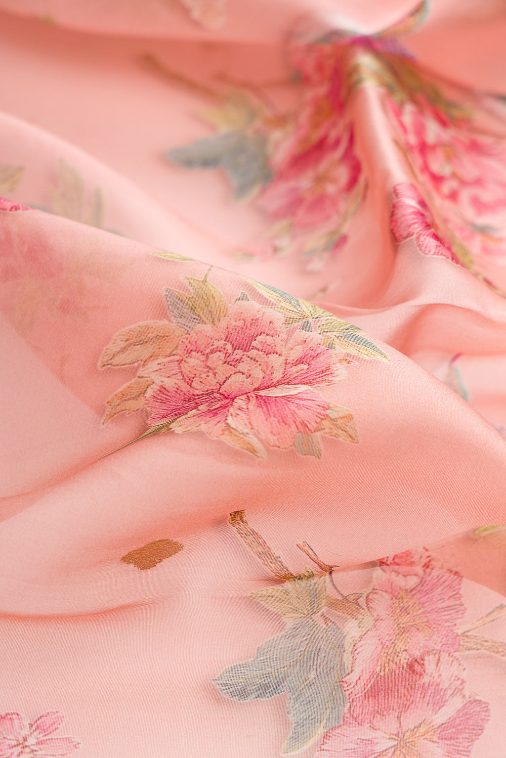Close up of Golden Peach Organza Saree with Printed design on the body and Fancy Border.  displaying folds