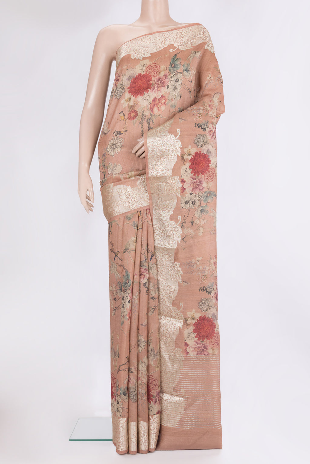 Rose Gold Tussar Saree with Floral Print on the body and Zari Border.  displayed on a mannequin