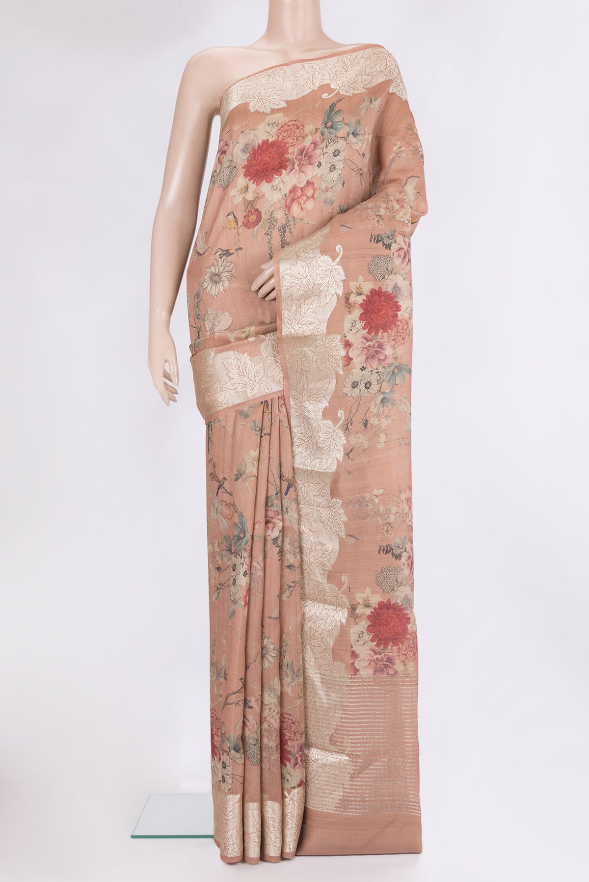 Rose Gold Tussar Saree with Floral Print on the body and Zari Border.  displayed on a mannequin
