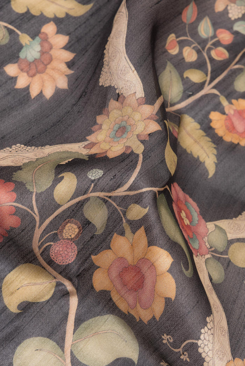 Close up of Pure Silk Black Tussar Saree with Printed design on the body and Fancy Border.  displaying folds