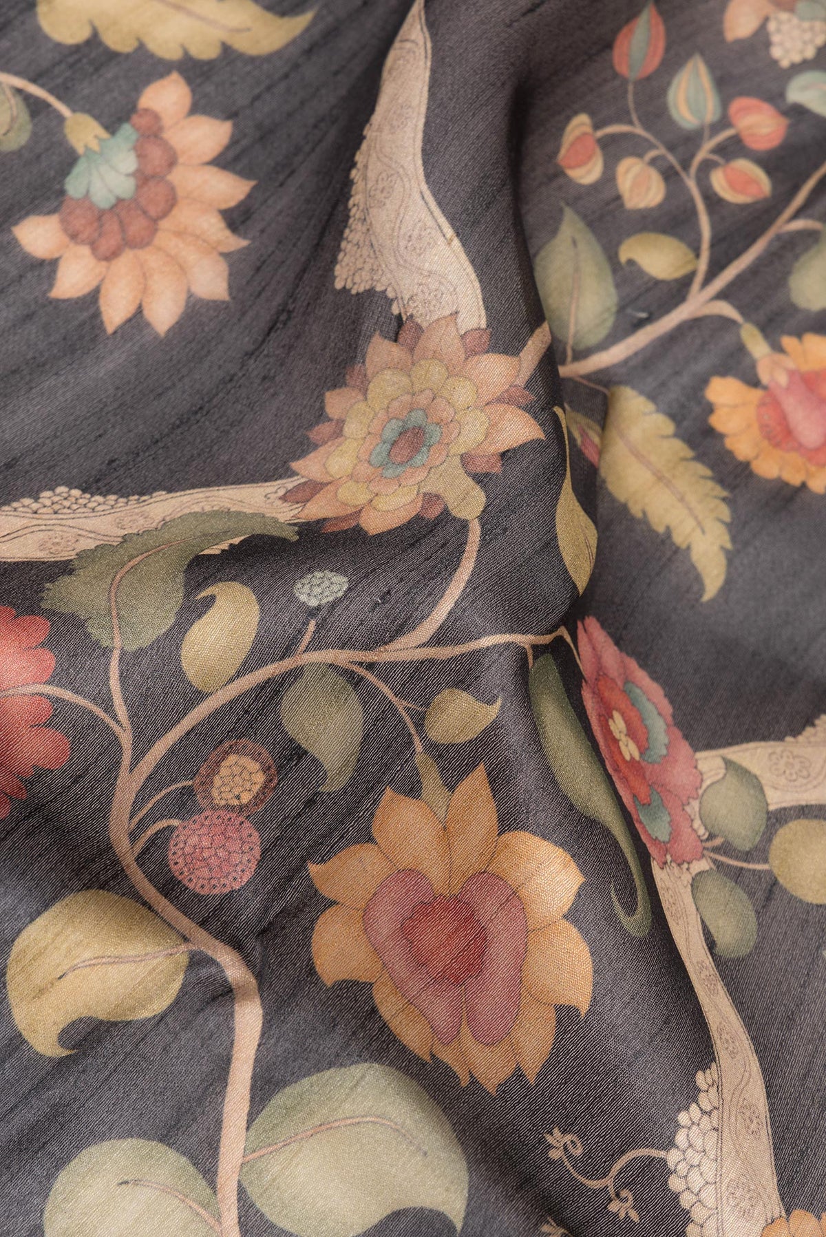 Close up of Pure Silk Black Tussar Saree with Printed design on the body and Fancy Border.  displaying folds