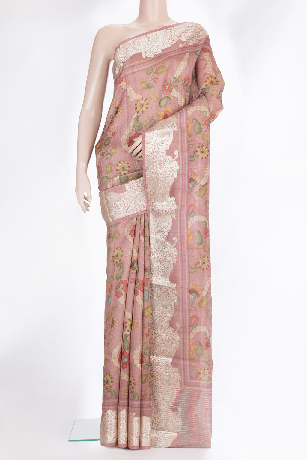 Peach Tussar Saree with Printed design on the body and Zari Border.  displayed on a mannequin