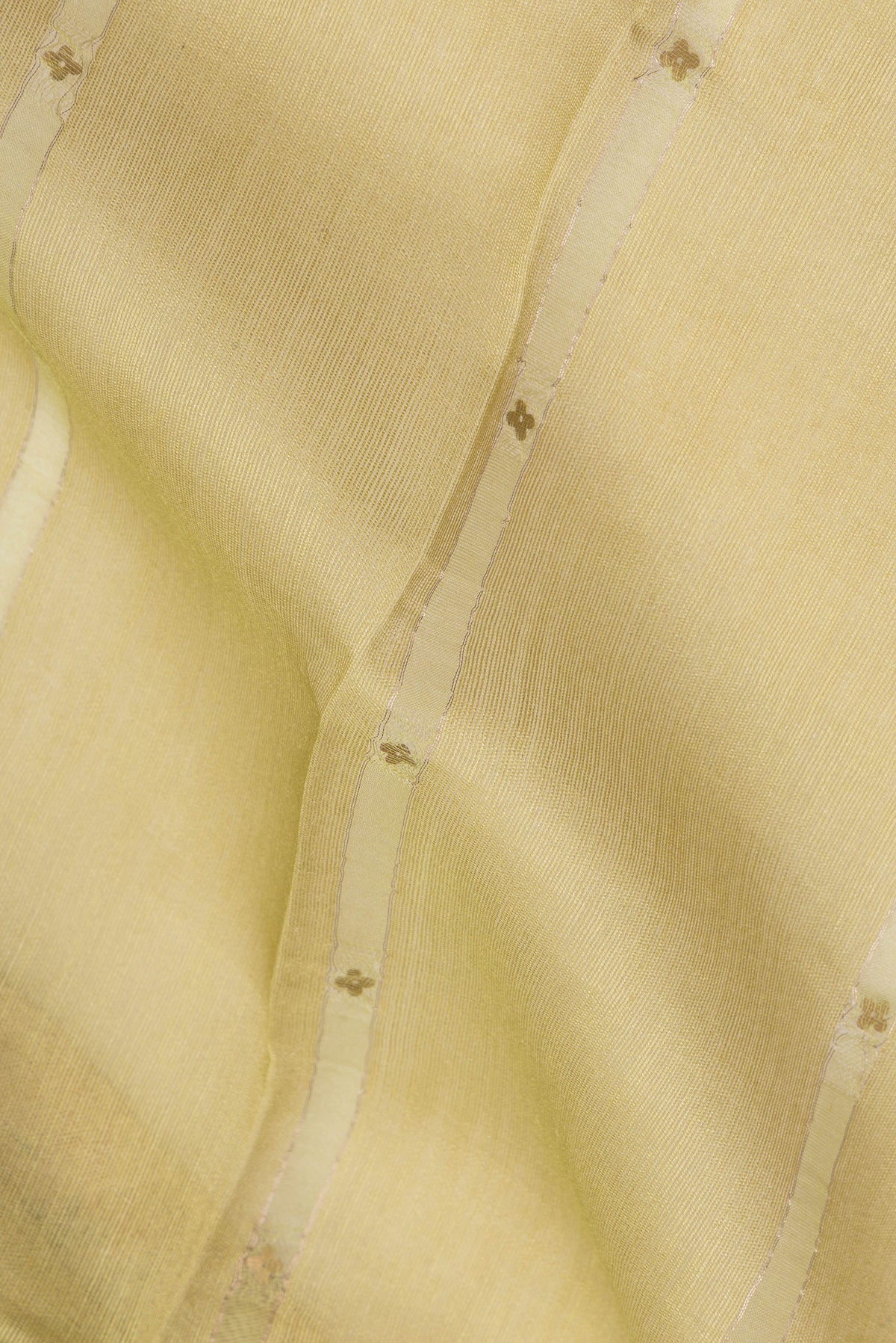 Close up of Lemon Yellow Tussar Saree with Stripes on the body and Fancy Border.  displaying folds