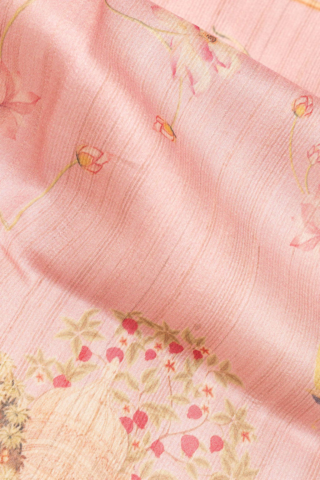 Close up of Peach Tussar Saree with Printed design on the body and Thread Border.  displaying folds