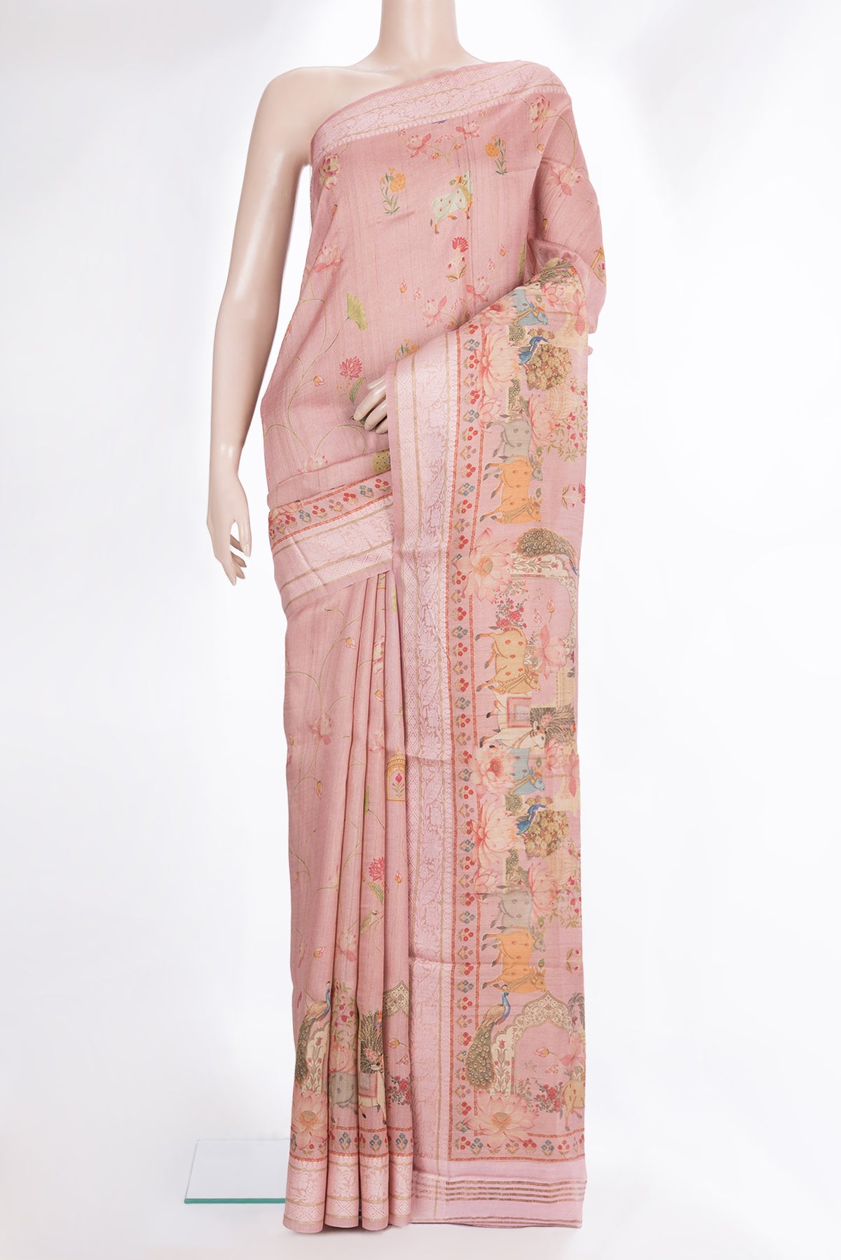 Peach Tussar Saree with Printed design on the body and Thread Border.  displayed on a mannequin