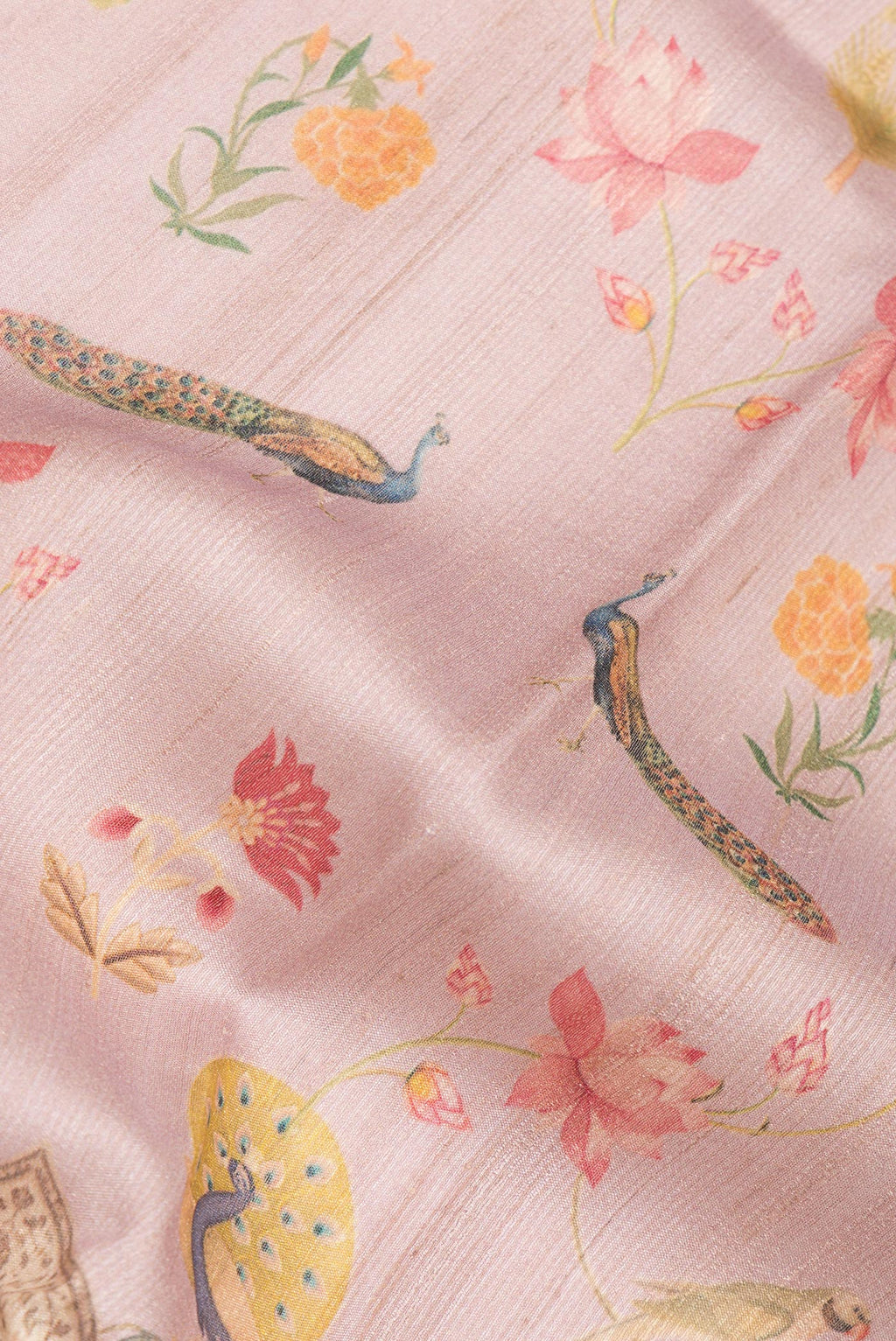 Close up of Rose Gold Tussar Saree with Printed design on the body and Thread Border.  displaying folds