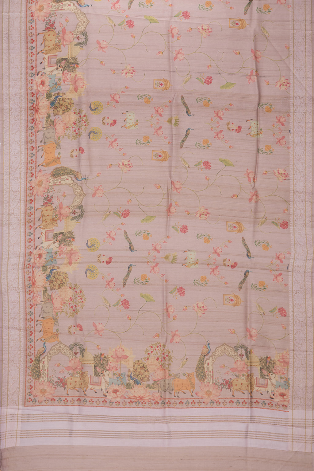Flat view of Rose Gold Tussar Saree with Printed design on the body and Thread Border. 