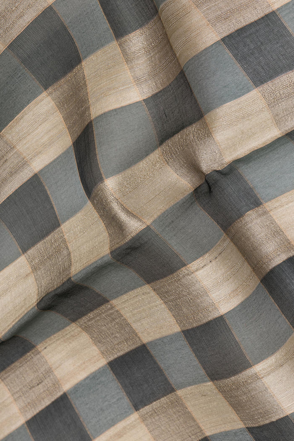 Close up of Multi Color Tussar Saree with Checked design on the body and Zari Border.  displaying folds
