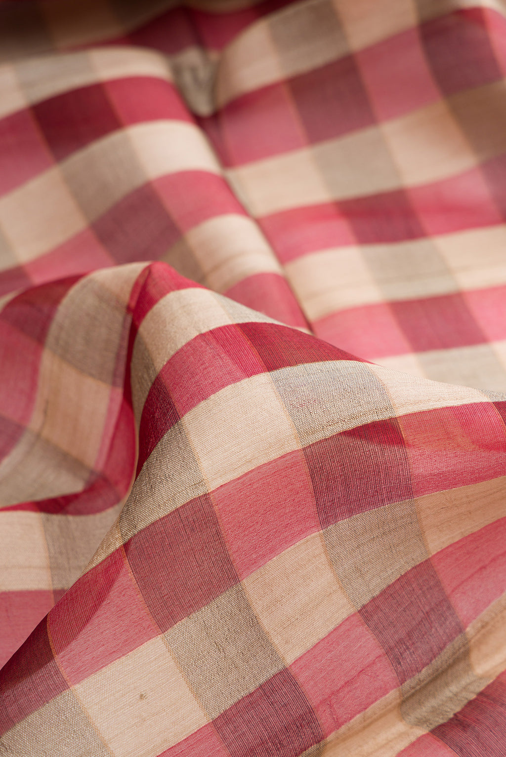 Close up of Multi Color Tussar Saree with Checked design on the body and Zari Border.  displaying folds