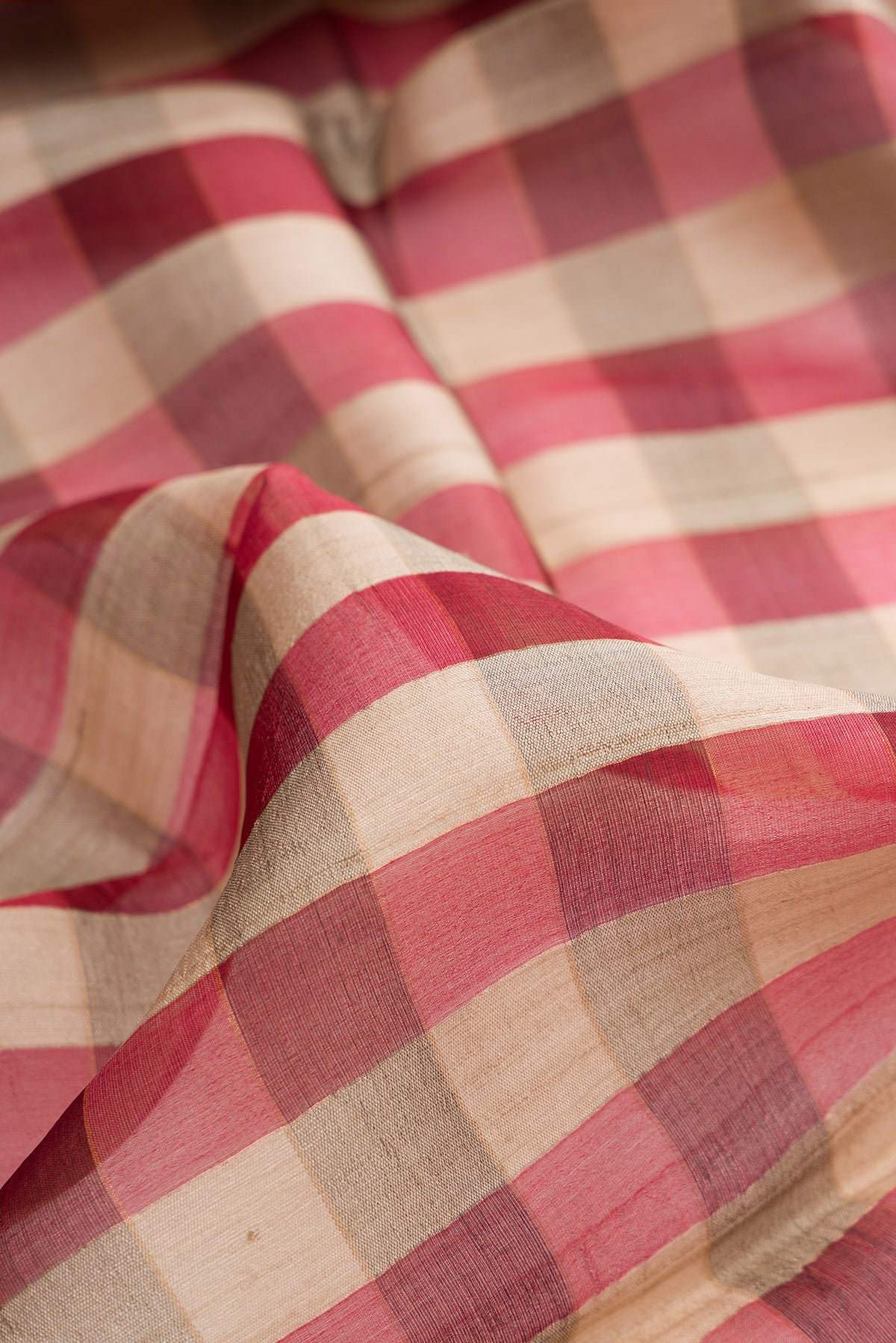 Close up of Multi Color Tussar Saree with Checked design on the body and Zari Border.  displaying folds