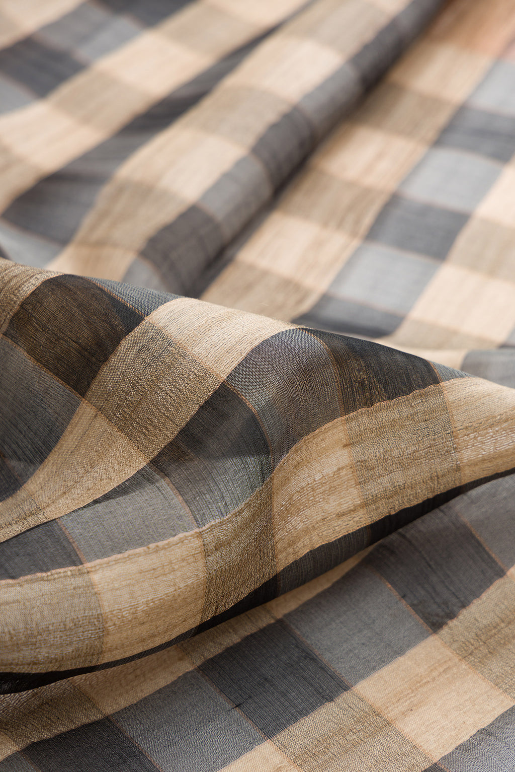 Close up of Multi Color Tussar Saree with Checked design on the body and Zari Border.  displaying folds