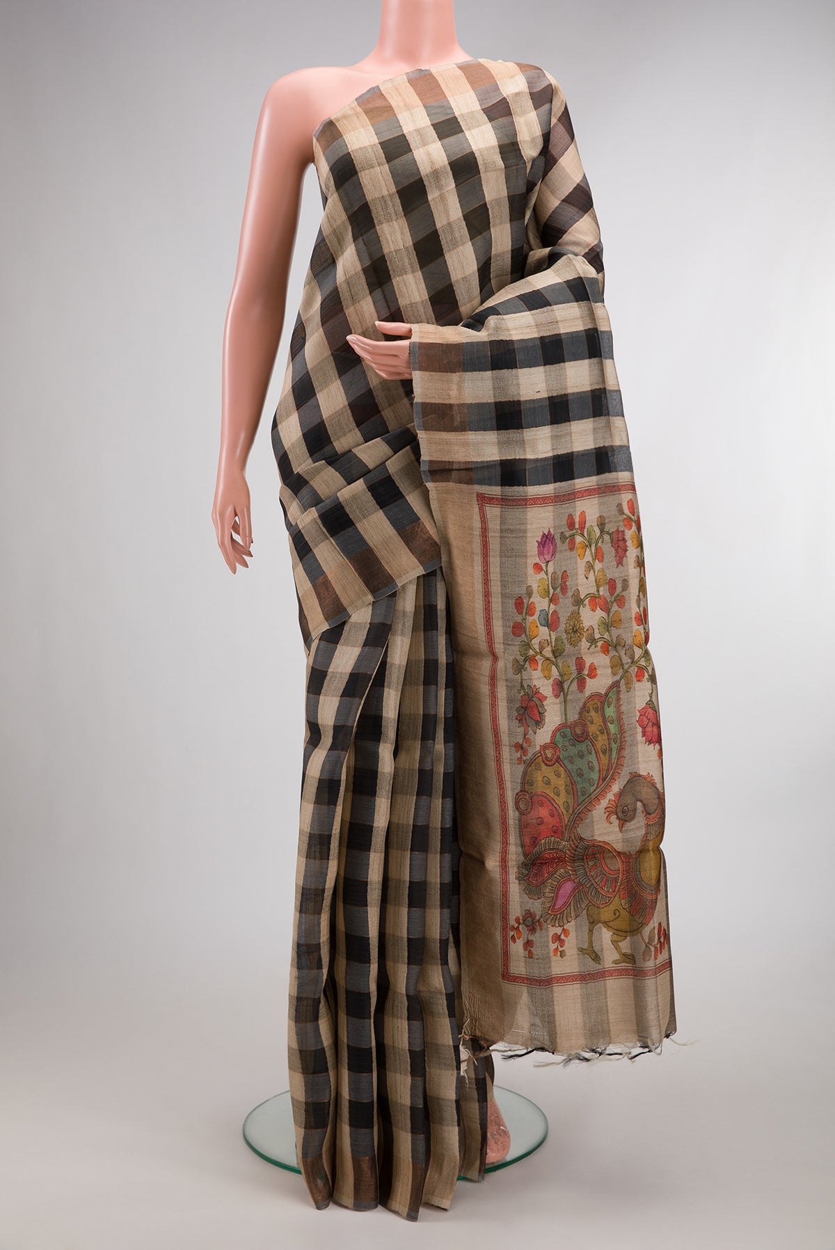Multi Color Tussar Saree with Checked design on the body and Zari Border.  displayed on a mannequin
