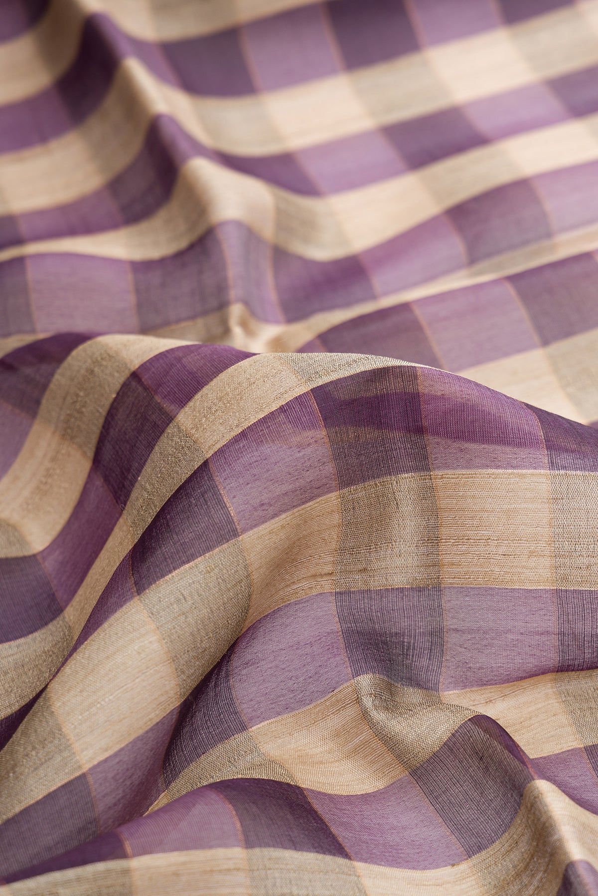 Close up of Multi Color Tussar Saree with Checked design on the body and Zari Border.  displaying folds