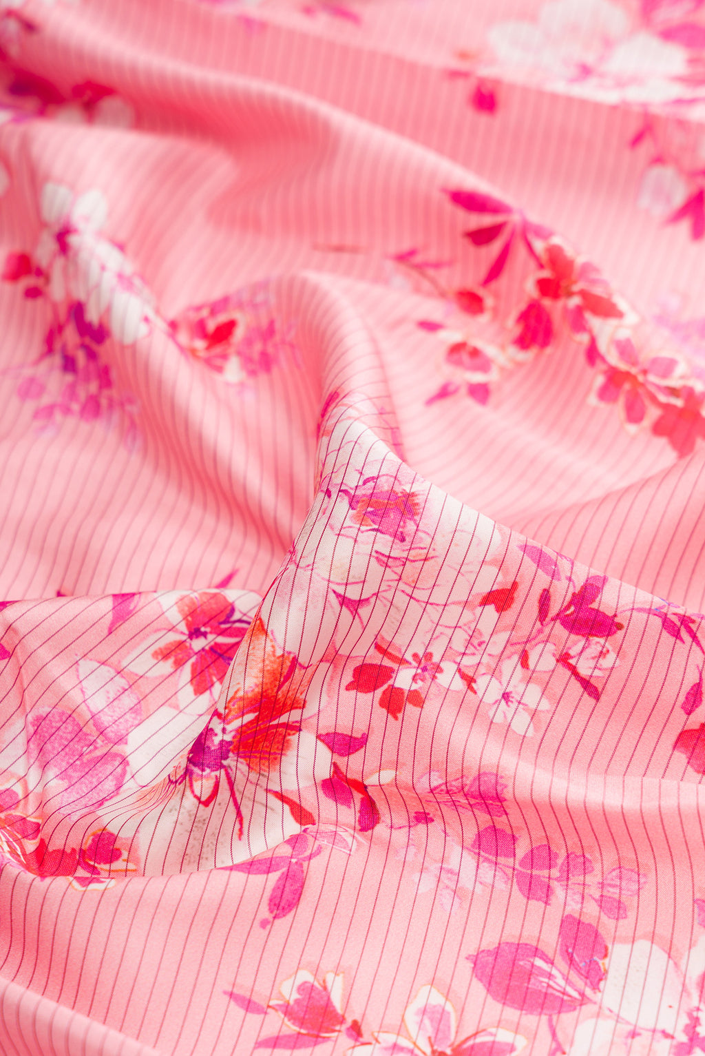 Close up of Pink Kanchipuram Silk Saree with Printed design on the body and Plain Border.  displaying folds