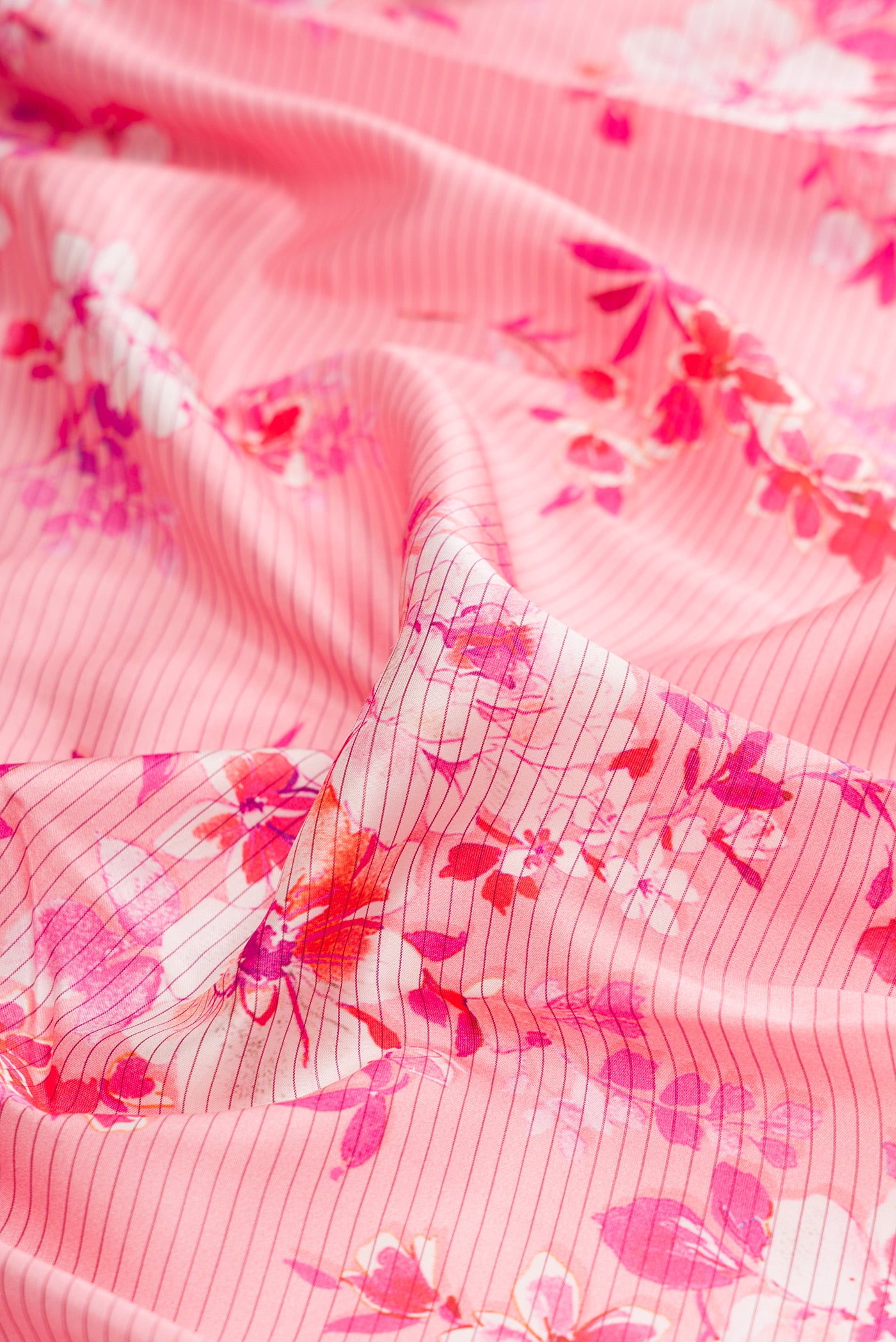 Close up of Pink Kanchipuram Silk Saree with Printed design on the body and Plain Border.  displaying folds