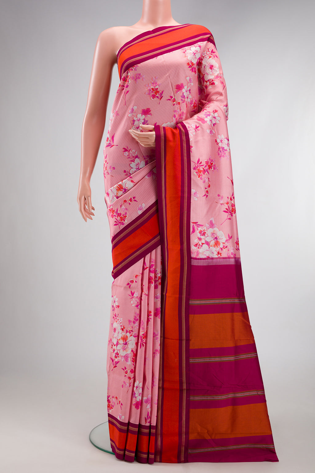 Pink Kanchipuram Silk Saree with Printed design on the body and Plain Border.  displayed on a mannequin