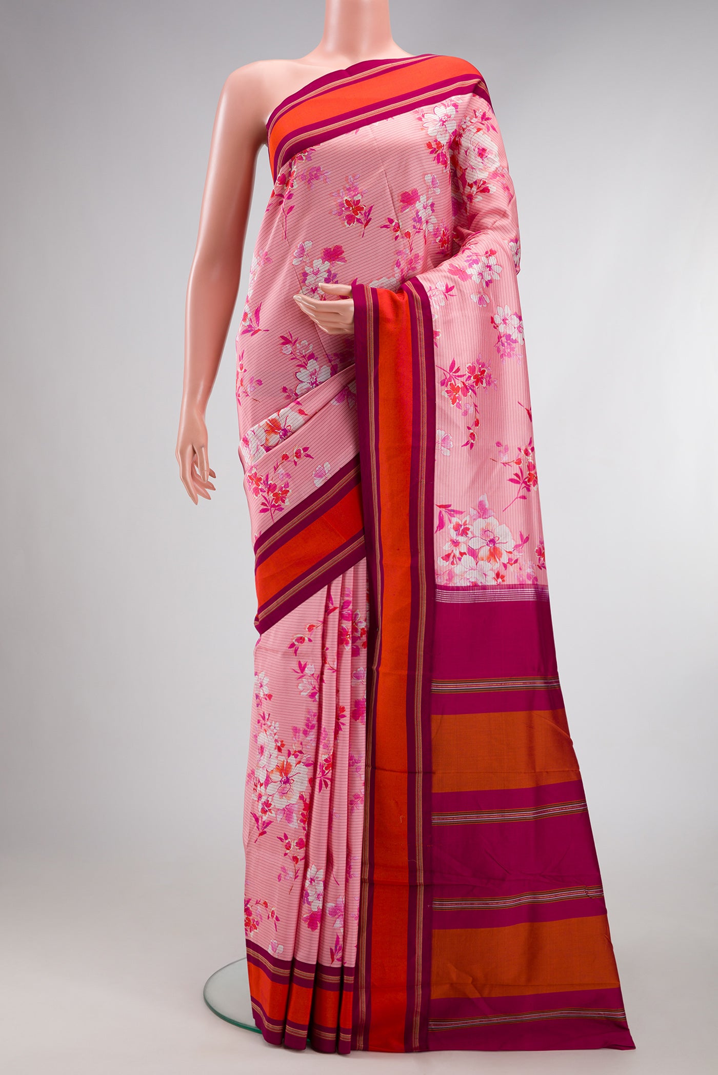 Pink Kanchipuram Silk Saree with Printed design on the body and Plain Border.  displayed on a mannequin