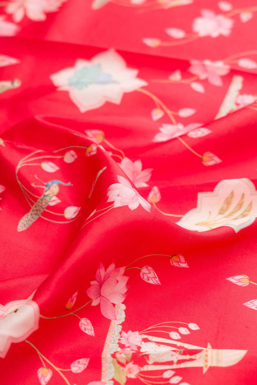 Close up of Red Kanchipuram Silk Saree with Printed design on the body and Plain Border.  displaying folds