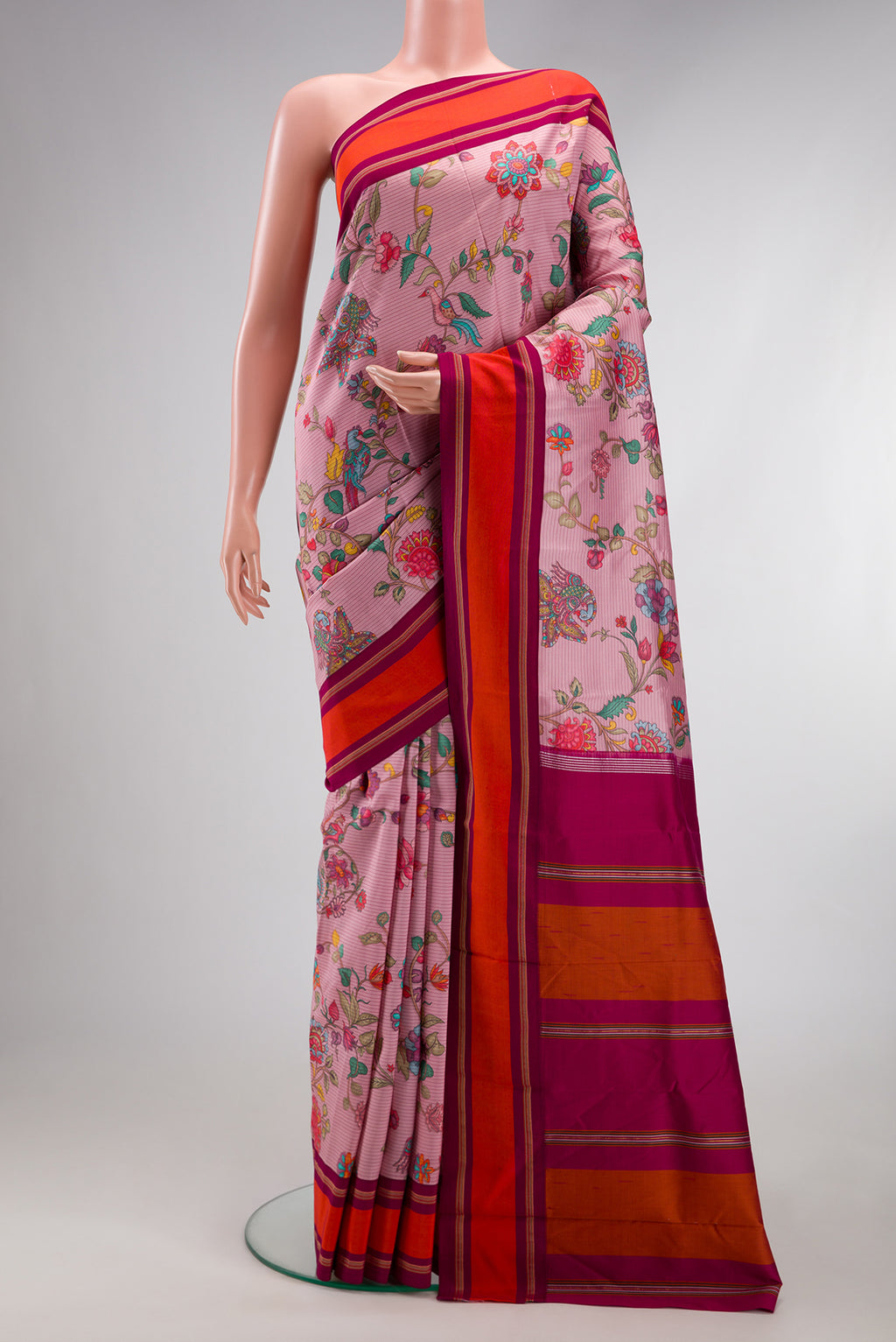 Pink Kanchipuram Silk Saree with Printed design on the body and Plain Border.  displayed on a mannequin