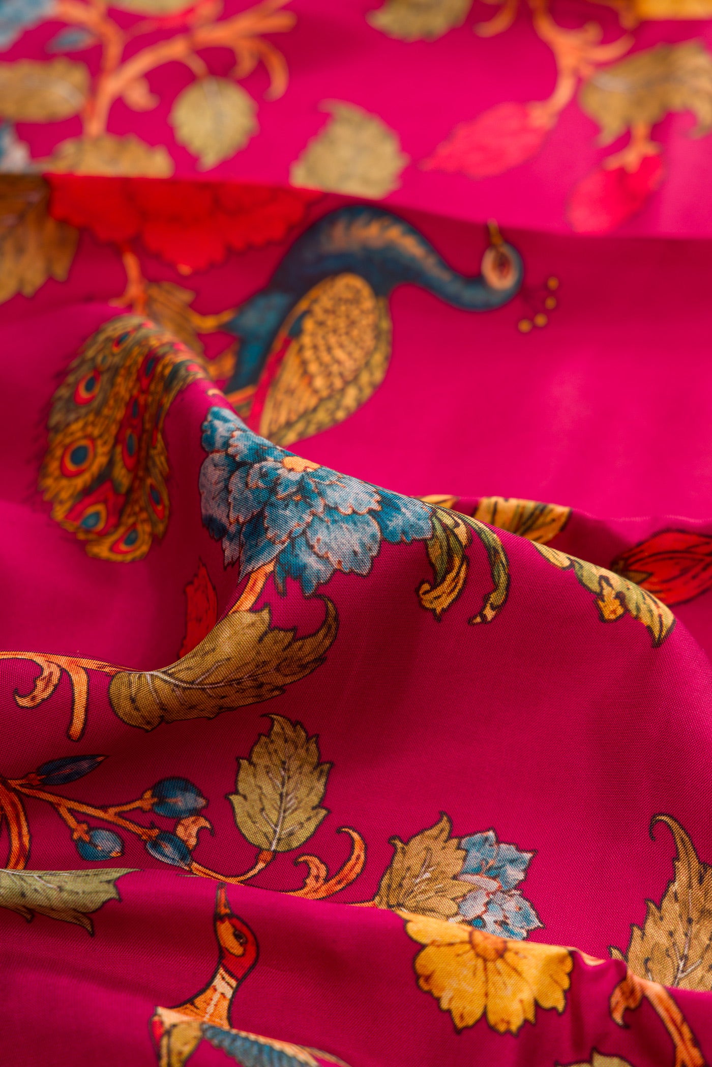 Close up of Dark Pink Kanchipuram Silk Saree with Printed design on the body and Zari Border.  displaying folds