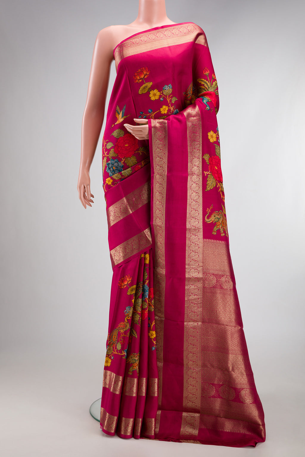 Dark Pink Kanchipuram Silk Saree with Printed design on the body and Zari Border.  displayed on a mannequin