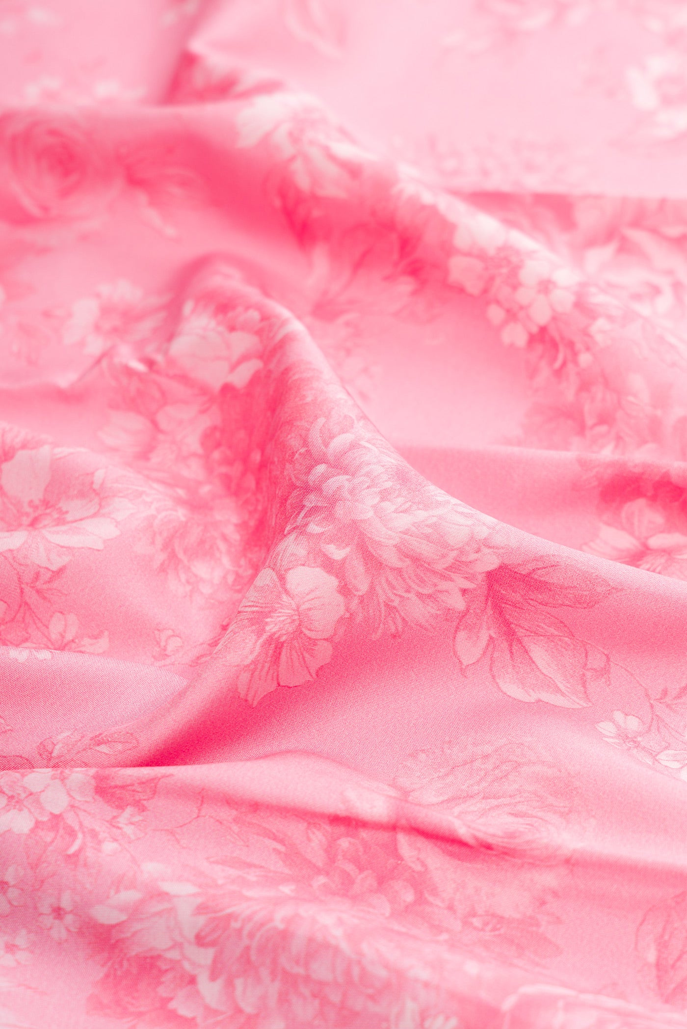 Close up of Pink Kanchipuram Silk Saree with Printed design on the body and Plain Border.  displaying folds