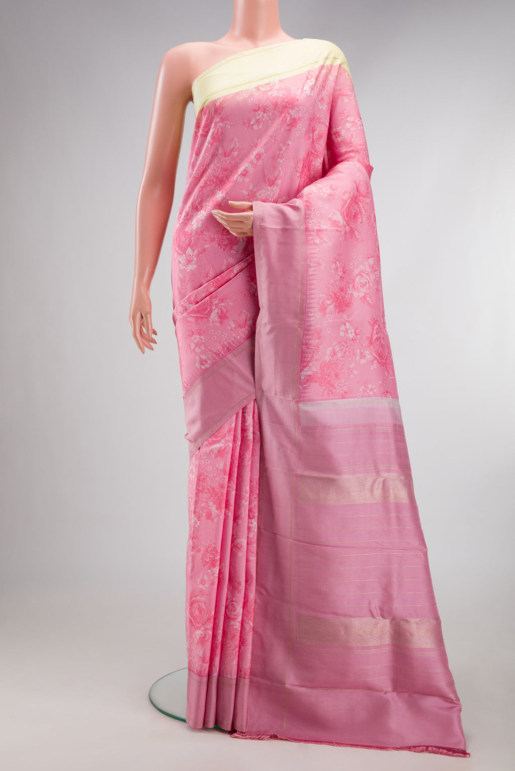 Pink Kanchipuram Silk Saree with Printed design on the body and Plain Border.  displayed on a mannequin