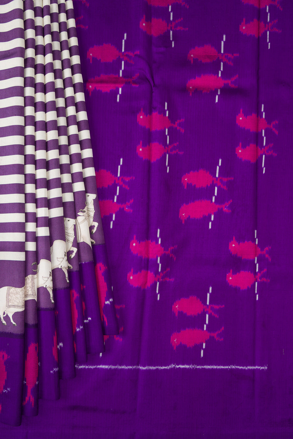 Pleats and pallu of Purple Kanchipuram Silk Saree with Printed design on the body and Ikat Border. 