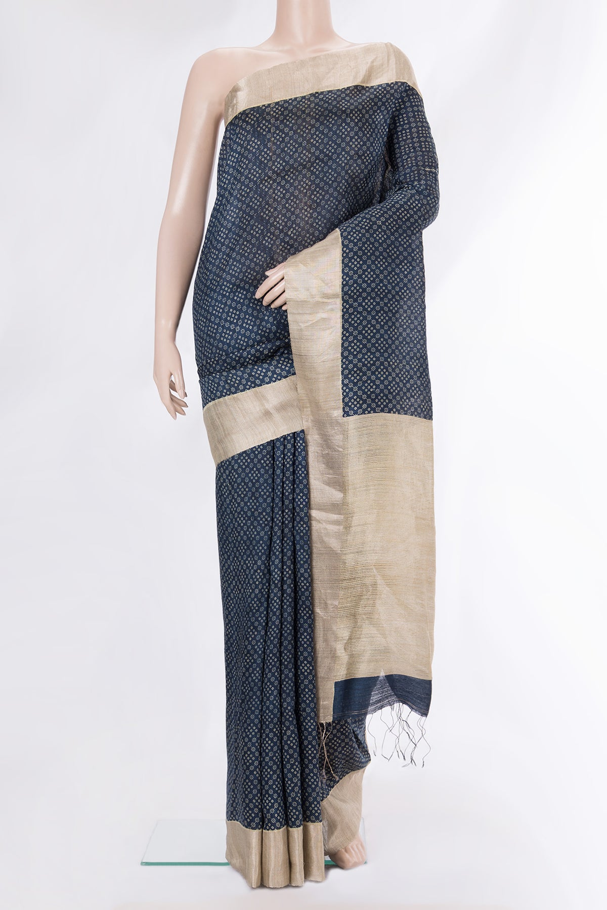 Navy Blue Tussar Saree with Bandhani Print on the body and Zari Border.  displayed on a mannequin
