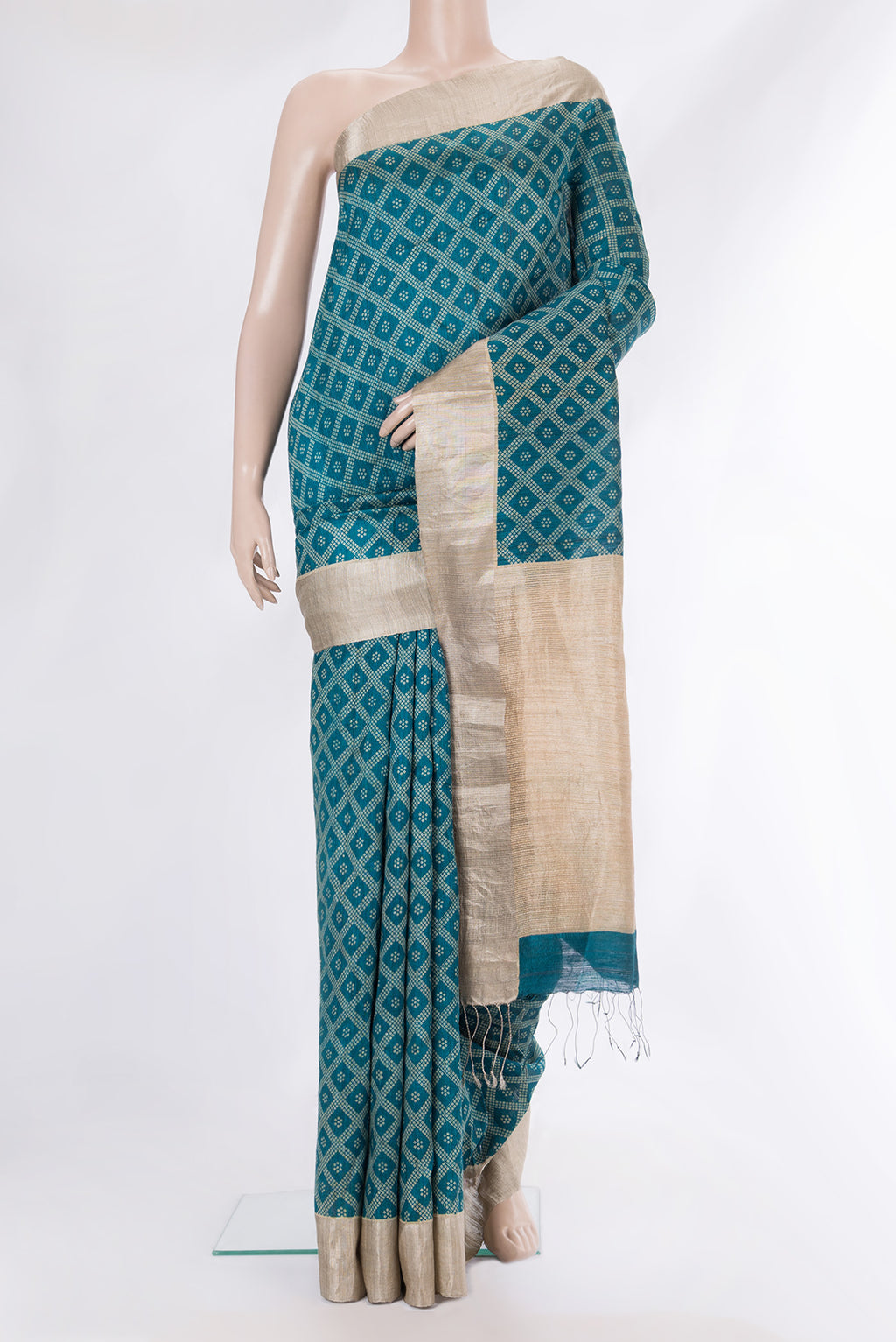 Pure Silk Teal Tussar Saree with Bandhani Print on the body and Zari Border.  displayed on a mannequin